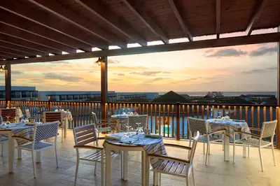 a restaurant with tables and chairs on a balcony at Melia Llana Beach Resort & Spa - Adults Only - All Inclusive in Santa Maria