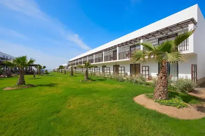 a building with palm trees in front of it at Melia Llana Beach Resort & Spa - Adults Only - All Inclusive in Santa Maria
