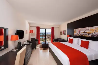 a hotel room with a large bed and a television at Melia Llana Beach Resort & Spa - Adults Only - All Inclusive in Santa Maria