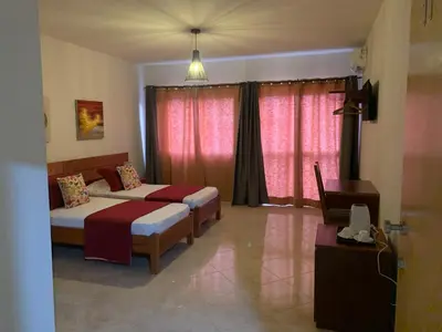 a bedroom with two beds and a window at Damfjord Boutique Hotel in Santa Maria