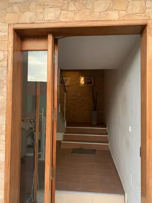an open door of a house with a staircase at Damfjord Boutique Hotel in Santa Maria