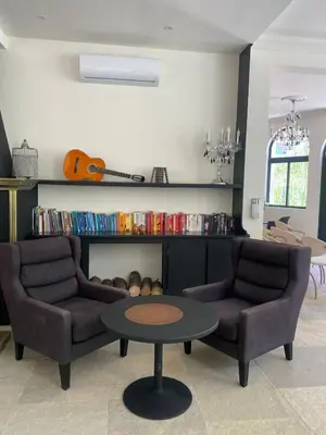 a living room with two chairs and a table at Hotel Château Georgette in Pombas