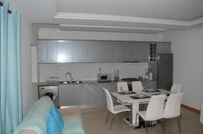 a kitchen with a table and chairs in a room at La Terraça in Praia