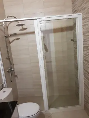 a bathroom with a shower with a toilet and a sink at Casa JPi in São Pedro
