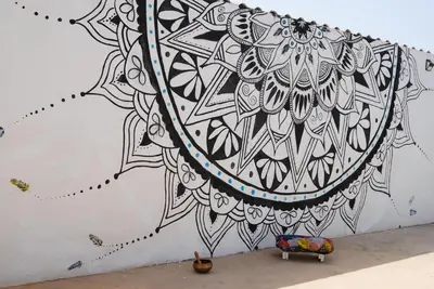 a wall with a mandala painted on it at AMA Apartament Ponta Preta in Calheta Do Maio