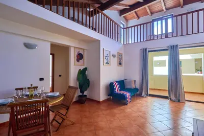 a living room with a table and a chair at Patio Antigo Residence in Santa Maria