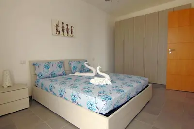 a bedroom with a bed with white swans on it at Zodiaco Apartments in Sal Rei