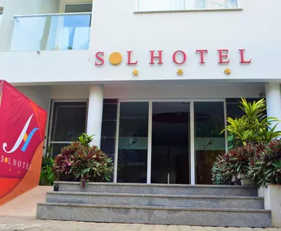 a hotel with a red flag in front of a building at Sol Hotel in Praia