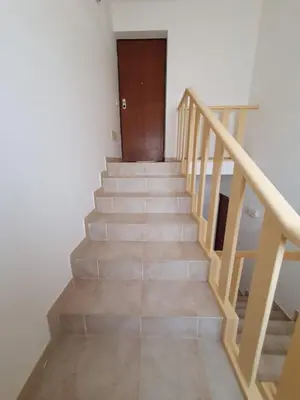 a staircase with a wooden door and a wooden stair case at Santa Maria Borgo Verde Apartment T2 in Santa Maria