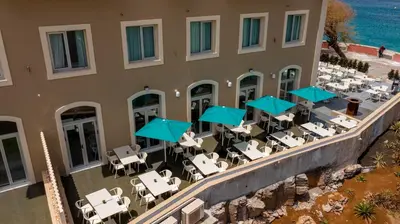 an aerial view of a hotel with tables and chairs at Oasis Tarrafal Alfandega Suites in Tarrafal