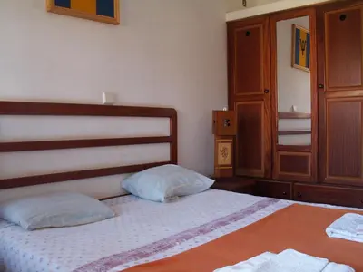 a bedroom with a bed with two pillows on it at Edificio Magico in Tarrafal