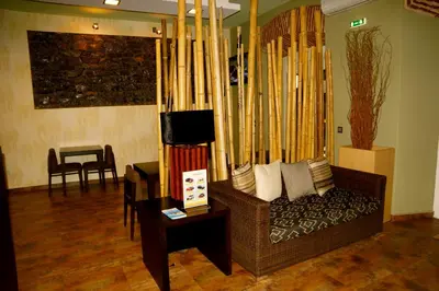 a living room with a couch and a bunch of skis at Hotel Praia Confort in Praia