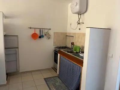 a small kitchen with a sink and a refrigerator at Beach Rotxa in Vila do Maio