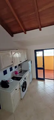 a kitchen with a stove and a washing machine at Sal Service new studio penthouse in Santa Maria