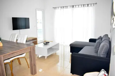 a living room with a couch and a tv in it at Lovely - Luxury 2 Bedrooms 500m from the Beach in Santa Maria