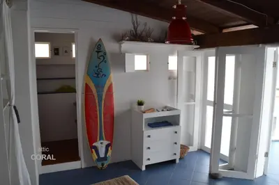 a surfboard leaning against a wall in a room at BookingBoavista - Apartments in Sal Rei