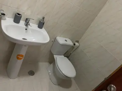 a bathroom with a toilet and a sink at Apartamento Vila Santa Bárbara ,Bloco F RChão Dirt,Santo Antão,Cabo Verde in Mão para Trás