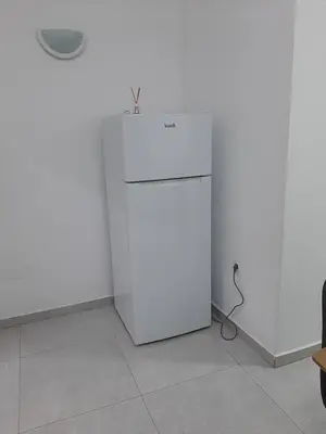 a white refrigerator in a room with a wall at Núria's Apartment in Mindelo