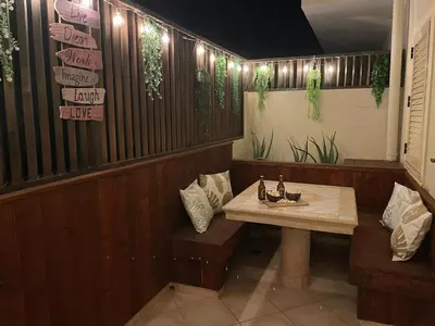 a restaurant with a table and benches in a room at Cacau's Home - By Albis Harena in Santa Maria
