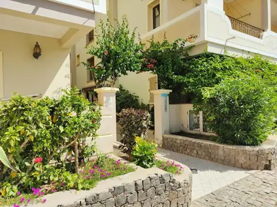 a building with flowers and plants in front of it at Cacau's Home - By Albis Harena in Santa Maria