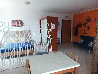 a room with a bed and a table in a room at Relaxed Home to calm in Santa Maria