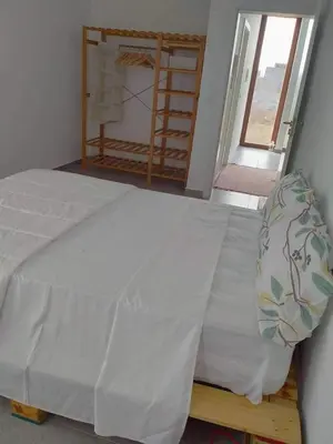 a large bed in a room with a window at Kyaala Suítes - pool & sea view in Praia