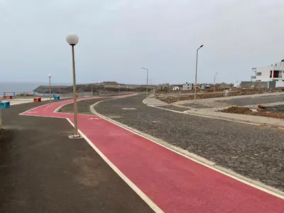 a street with red and pink paint on the road at Kyaala Suítes - pool & sea view in Praia