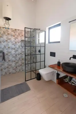 a bathroom with a sink and a toilet and a shower at New Rooftop Gem with stunning Oceanview in Santa Maria