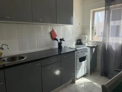 a kitchen with a sink and a stove at Apartamento T2-Dunas Centro in Tarrafal