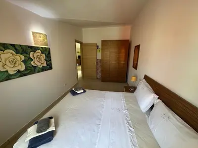 a bedroom with a large bed in a room at Holiday Properties Moradias Green in Santa Maria
