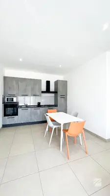 a kitchen with a white table and chairs at Ka Djula in Sal Rei