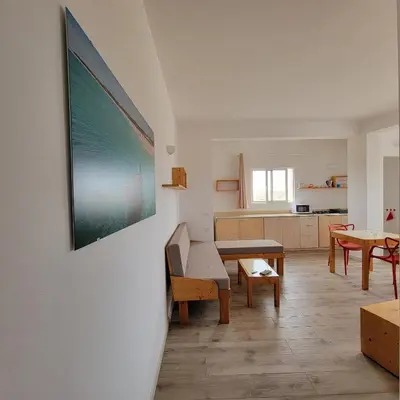 a living room with a couch and a table at Baia Palmeira Residence in Palmeira