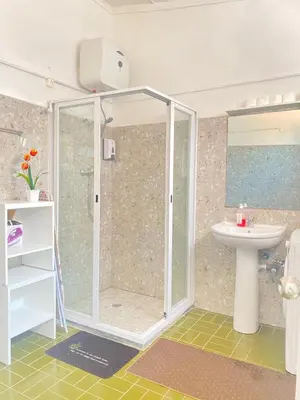 a bathroom with a shower and a sink at Best Rooms- Quarto 2 Plateau in Praia