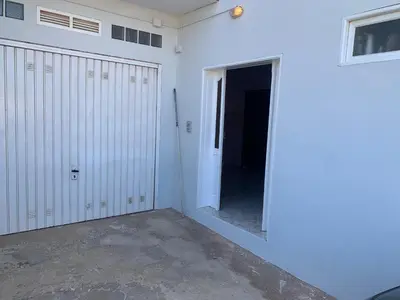 a garage with a door leading into a room at CA FILO in Espargos