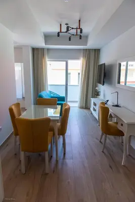 a living room with a dining room table and chairs at Santa Cruz Boutique Hotel in Mindelo
