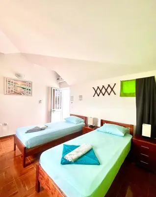 two beds in a room with two beds sidx sidx sidx sidx at Casa BB&Djassi - ROOMS in Ponta do Sol