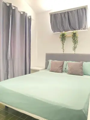 a large bed in a bedroom with purple curtains at Best Rooms - Quarto 1 Plateau in Praia