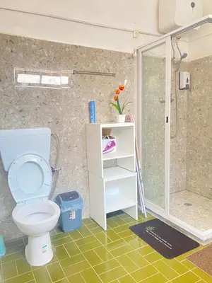 a bathroom with a toilet and a shower at Best Rooms - Quarto 1 Plateau in Praia