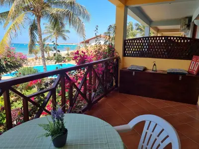 a balcony with a table and a view of the beach at Beach front ocean view Porto Antigo2 Santa Maria in Santa Maria