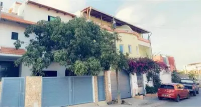a red car parked in front of a house at Apartamento t1 mobiliado com Wi-Fi in Praia