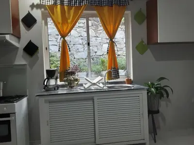 a kitchen with a sink and a window at Casa Familiar Pôr do Sol in Ribeira Grande