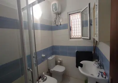 a bathroom with a toilet and a sink at Adult only beachfront 2 bedroom apartment Santa Maria airport pick up, aircon, unlimited wifi ideal for remote working and long stay in Santa Maria