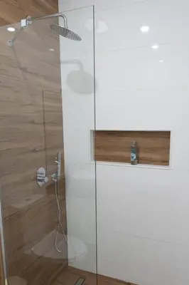 a shower with a glass door in a bathroom at 3 bdr aprt, best seaview, rooftop pool - LCGR in Praia