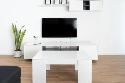 a white desk with a tv on top of it at 3 bdr aprt, best seaview, rooftop pool - LCGR in Praia