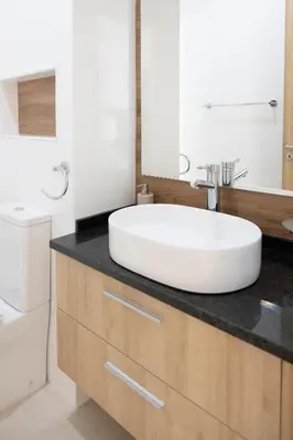 a bathroom with a large white sink on a counter at 3 bdr aprt, amazing seaview, rooftop pool - LCGR in Praia
