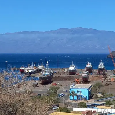 a group of ships are docked in a harbor at Recanto Verde Cara in Mindelo
