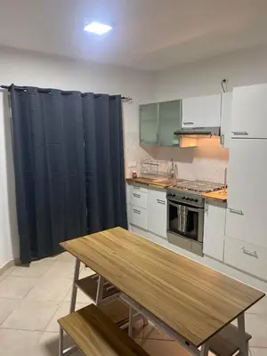 a kitchen with a wooden table in a kitchen at Murdeira Village V155A in Beirona