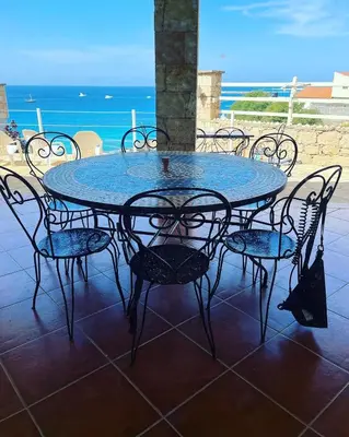 a table and chairs with a view of the ocean at Villa GÊMEO vue mer, piscine accès privé plage in Calheta Do Maio