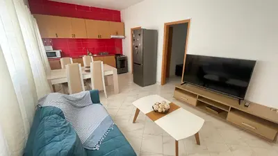 a living room with a blue couch and a television at Quick Stay in Praia #2 in Praia