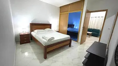 a bedroom with a bed and a door to a room at Quick Stay in Praia #2 in Praia